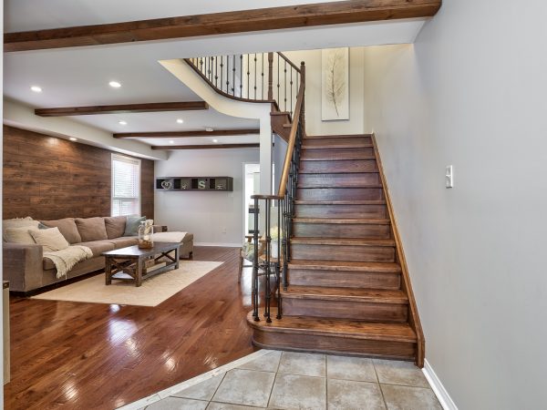 Oak Staircase with Metal Pickets Leads to Upper Level
